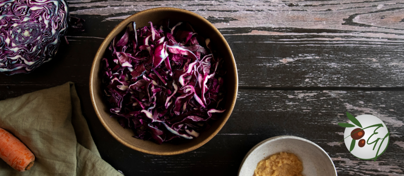 Red cabbage salad. Coleslaw in a bowl. Grey background. Close up.